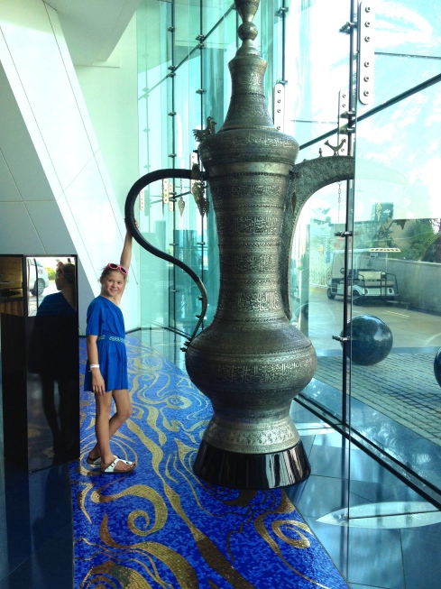 Molly in the lobby standing next to huge Arabic tea pot.